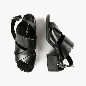 Top and side view of black criss cross strap sandals with block wood heels