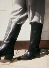 Load image into Gallery viewer, Woman wearing grey pants and black boots