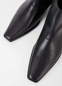 Close up of pointy toe black ankle boots