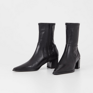 pair of black pointed stretch boots with zippers